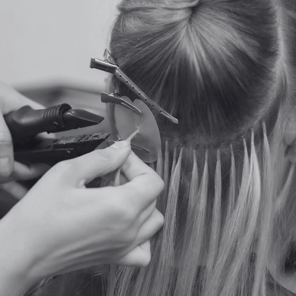 Pose d'extensions mèche par mèche sur des cheveux blonds